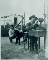 Artus sitting at a desk outdoors working on a vase - Click to enlarge